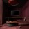 dark room with soundproofed walls and a mic on a table 