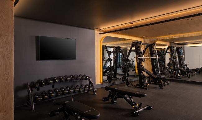 Wellness Just Steps Away a room with weights and exercise equipment
