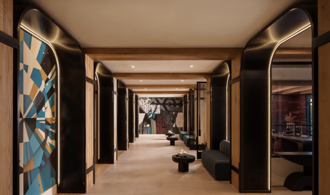 Where Home Begins a long hallway entrance with art on the walls