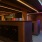 a room with mail boxes and colored tubes of light on the ceiling 