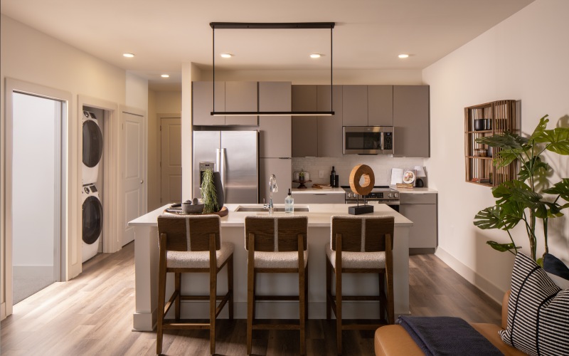 a kitchen with white counters and seating