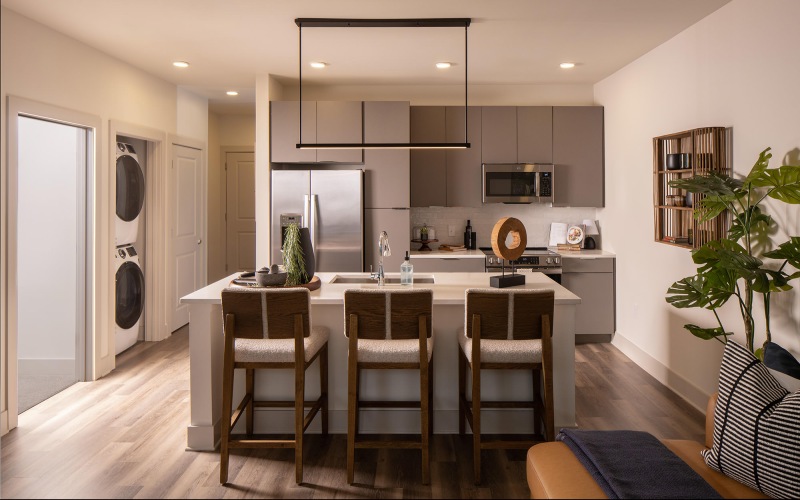 a kitchen with white counters and seating