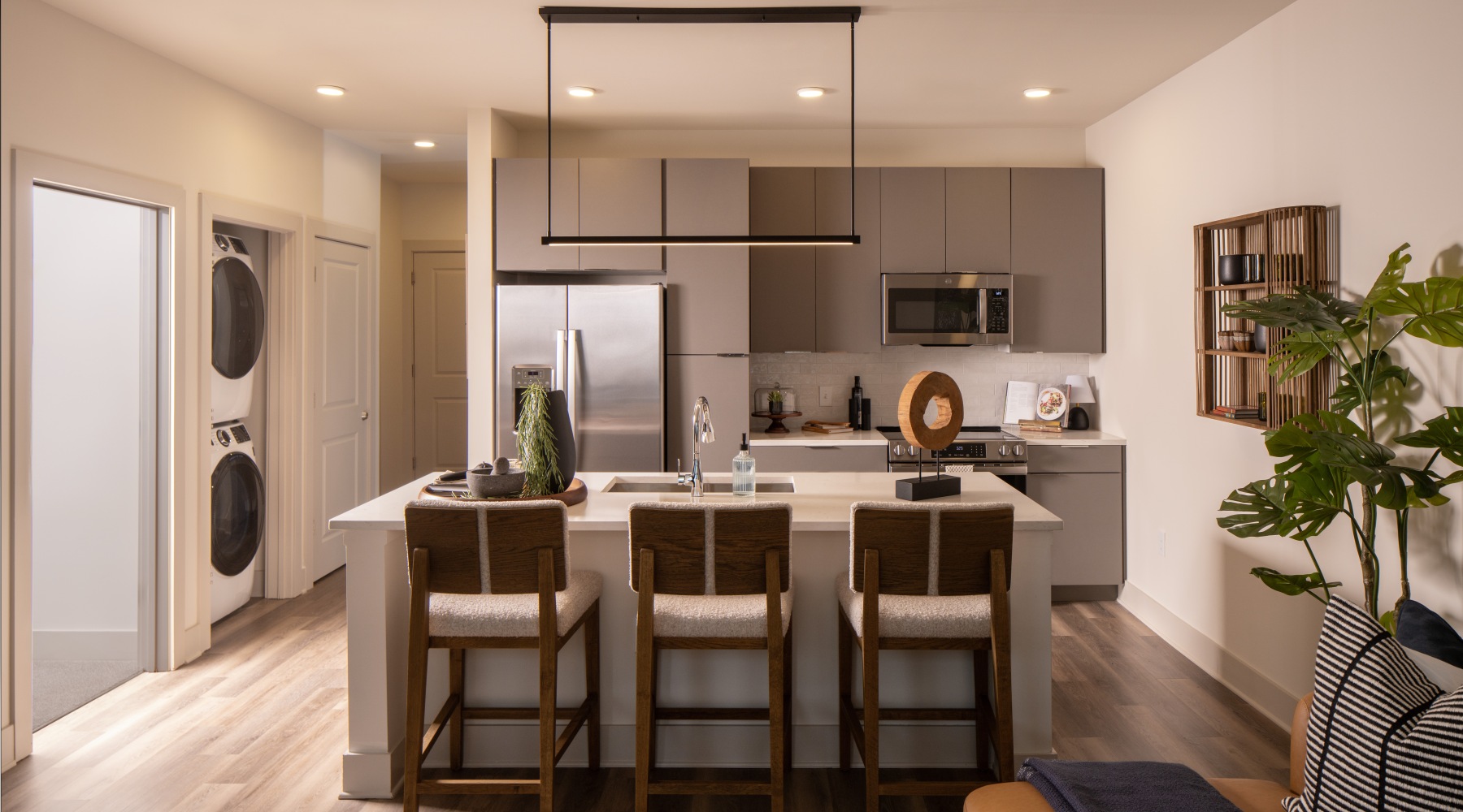 Gorgeous living areas to entertain and enjoy a kitchen with white counters and seating