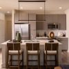 a kitchen with white counters and seating