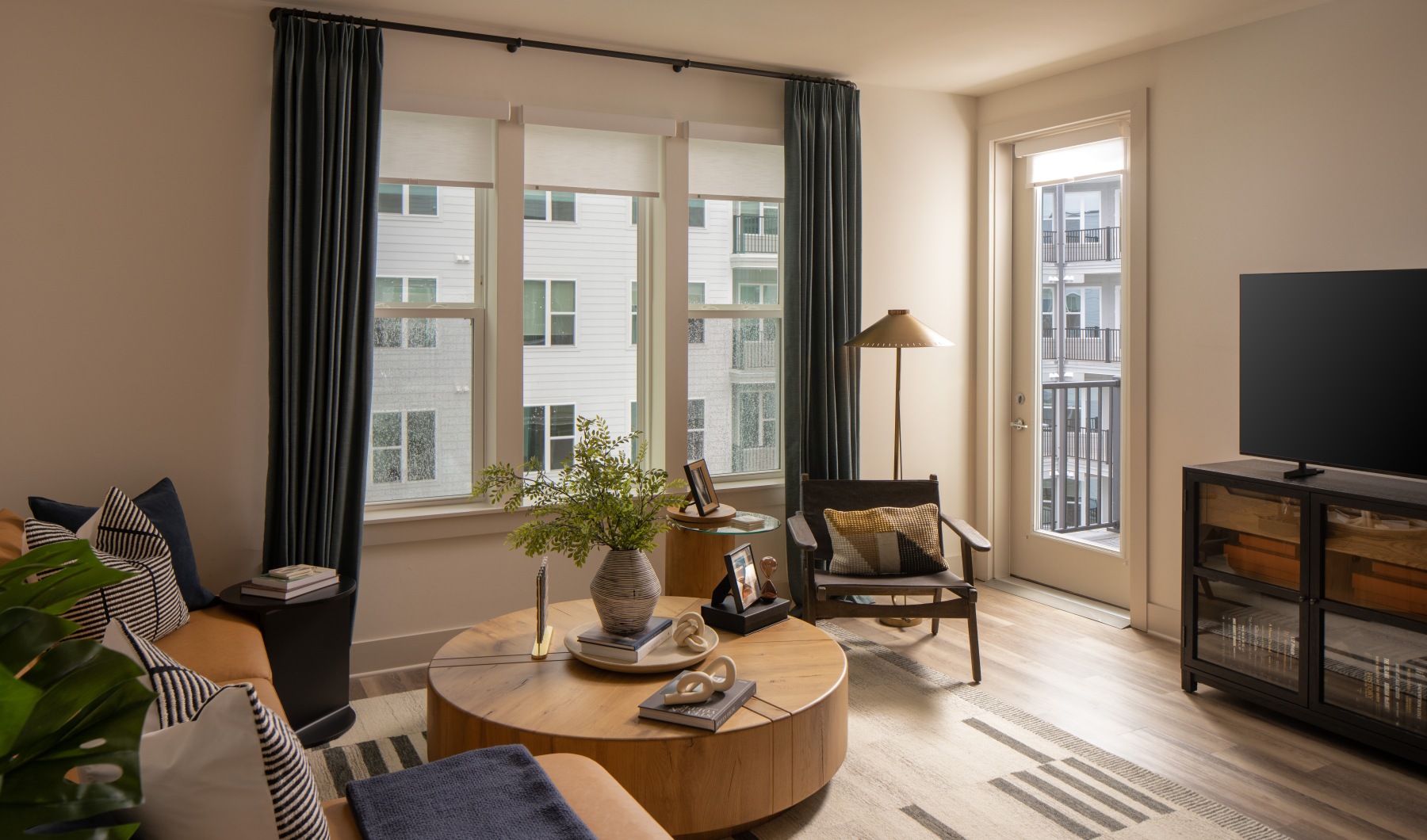 Spacious and well-lit living spaces well lit living room with large windows and seating